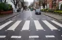 Zebra crossing on Abbey Road in London with a black cab further up the street
