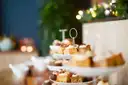 Small cakes and pastries on a tiered afternoon tea stand
