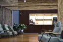 A quiet airport lounge with leather armchairs and a small coffee counter