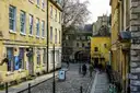 A cobbled street of honey-coloured Georgian buildings in Bath