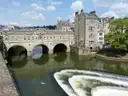Pulteney Bridge in Bath above the curved weir on the River Avon
