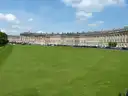 The curved Georgian terrace of the Royal Crescent in Bath behind a wide lawn