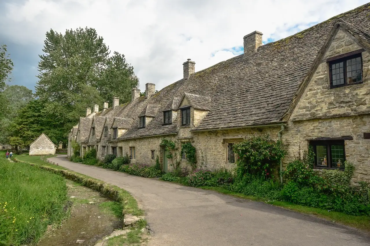 Old stone cottages of Arlington Row along a quiet lane in Bibury