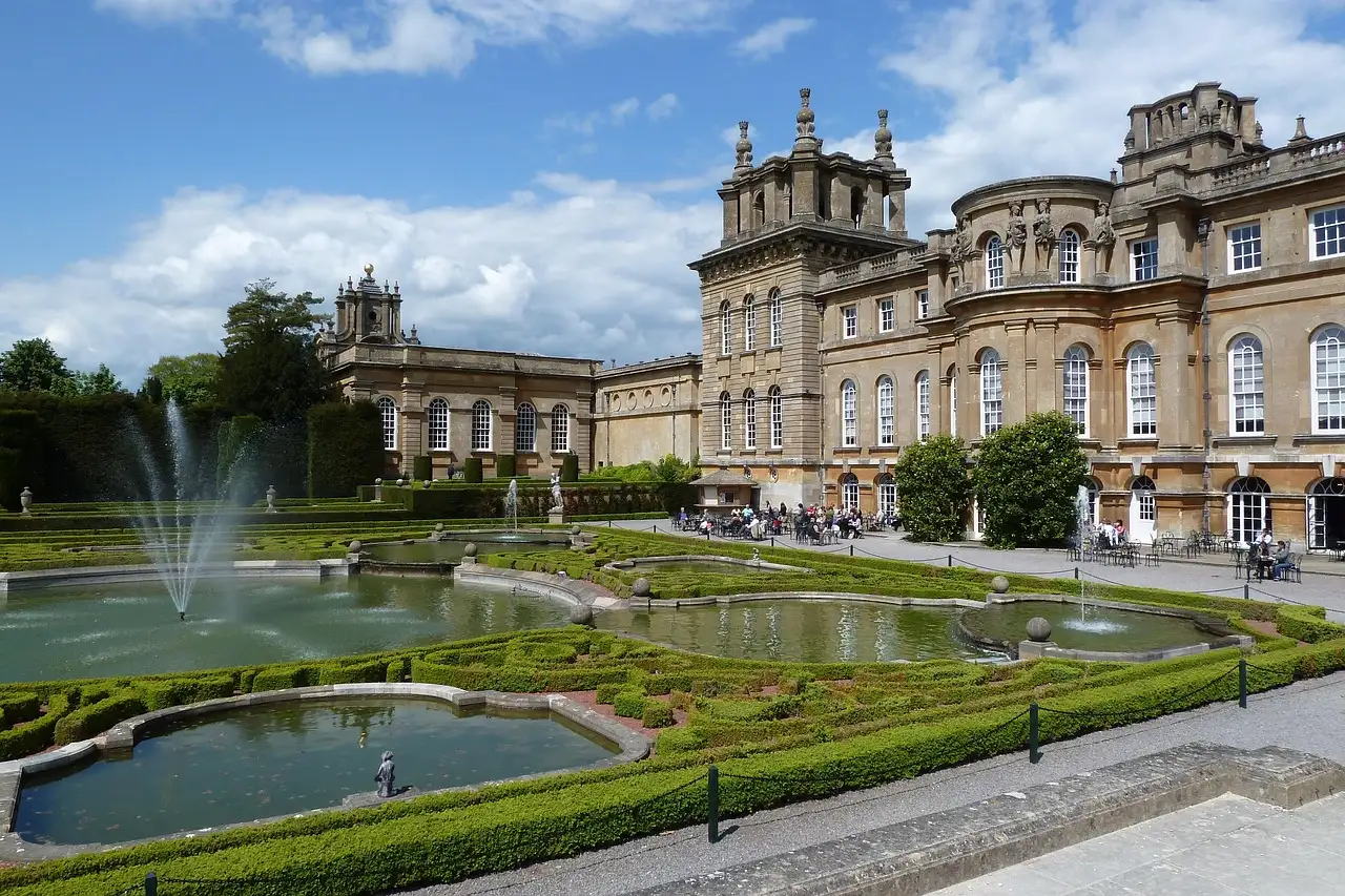 Blenheim Palace from its water terraces, with fountains and clipped hedges