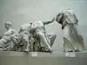 Headless marble figures from the Parthenon on display in a museum gallery
