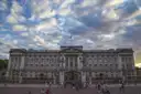 East front of Buckingham Palace under a dramatic cloudy sky