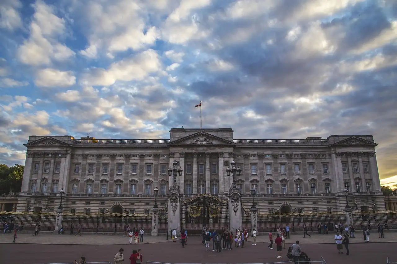 East front of Buckingham Palace under a dramatic cloudy sky