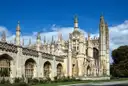 King's College Chapel and gatehouse in Cambridge under a blue sky