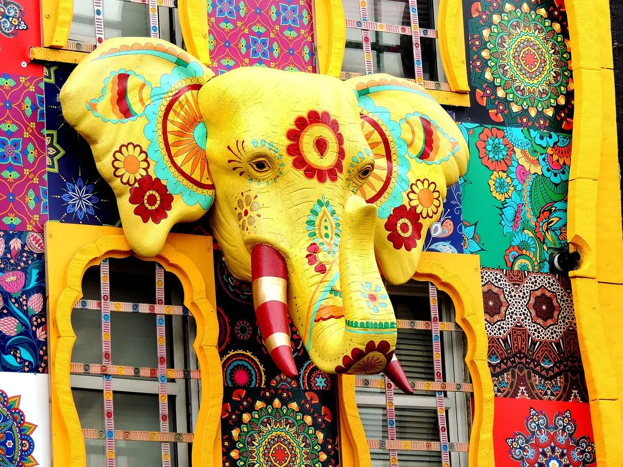 A giant painted elephant head on a colourful shopfront in Camden High Street