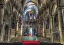 The steps to the choir and altar under Gothic arches inside Canterbury Cathedral