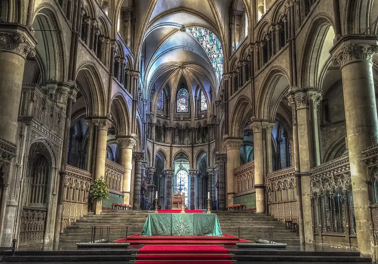 The steps to the choir and altar under Gothic arches inside Canterbury Cathedral