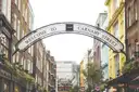 The Carnaby Street arch in Soho on a bright day