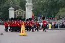 Guardsmen in red tunics and bearskin hats marching during the Changing of the Guard