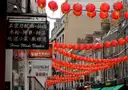 Red lanterns strung across a street in London's Chinatown