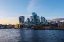 The City of London skyline seen across the River Thames in evening light