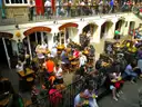 People eating and drinking at tables in the lower courtyard of Covent Garden Market