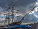 The Cutty Sark clipper ship at Greenwich under a dramatic sky