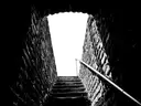Narrow stone stairs leading down into darkness