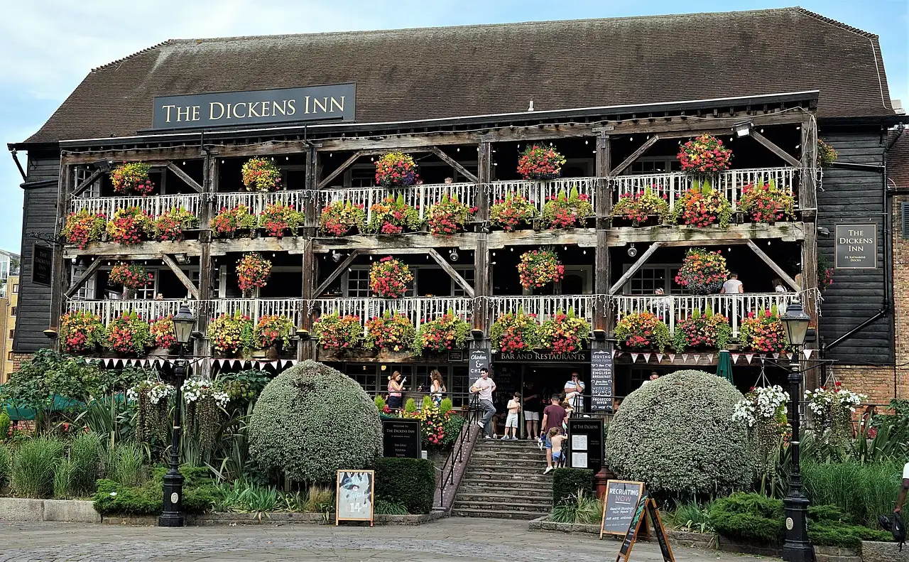 The timber-framed Dickens Inn pub at St Katharine Docks with flower-filled balconies