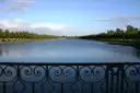 The Long Water canal at Hampton Court, seen over an ornate iron railing