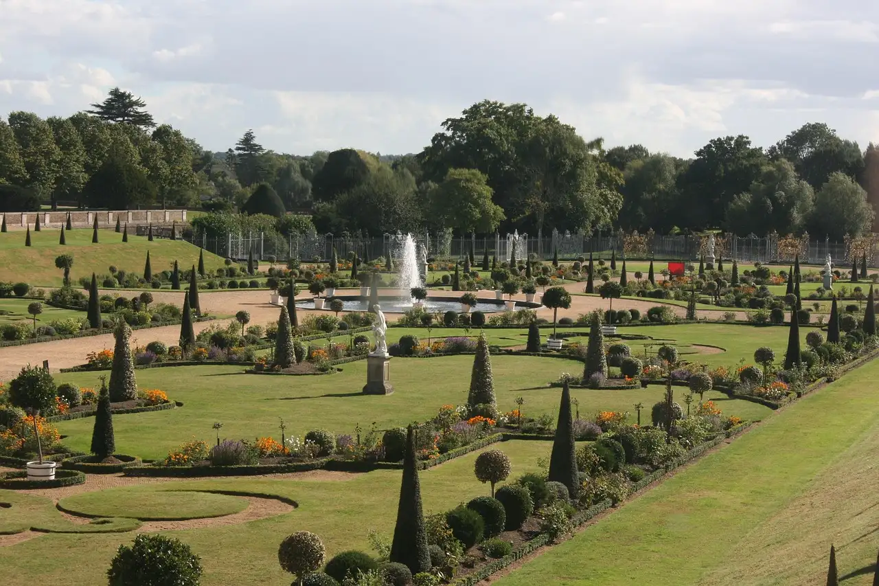 Formal gardens with clipped topiary and a fountain at Hampton Court Palace