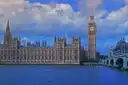Houses of Parliament and Big Ben across the River Thames under a blue sky