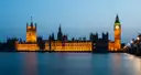 Houses of Parliament and Big Ben lit up at blue hour across the Thames
