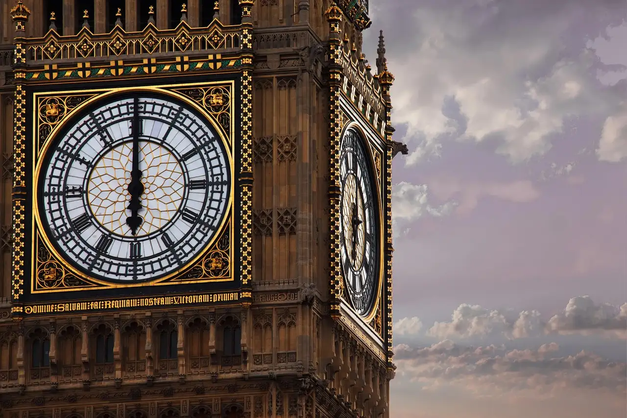 Close-up of the golden clock face of Big Ben with its black hands and Roman numerals
