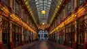 Empty covered arcade of Leadenhall Market with glass roof and hanging lanterns
