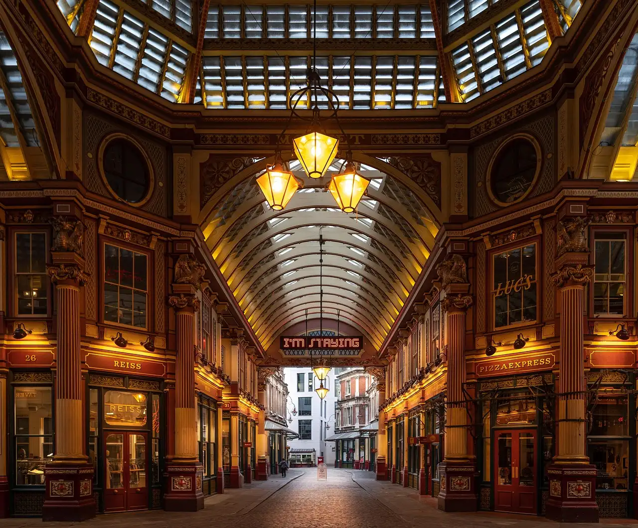 Leadenhall Market's Victorian arcade at dusk, with its lanterns lit