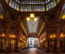 Leadenhall Market's Victorian arcade at dusk, with its lanterns lit