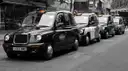Queue of black London cabs in a city street