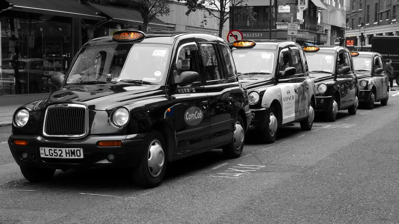 Queue of black London cabs in a city street