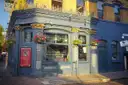 A Victorian corner pub in London with hanging flower baskets