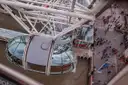 Looking down on a London Eye capsule and the riverside walk far below