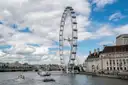 The London Eye and County Hall from the Thames, with small boats on the river