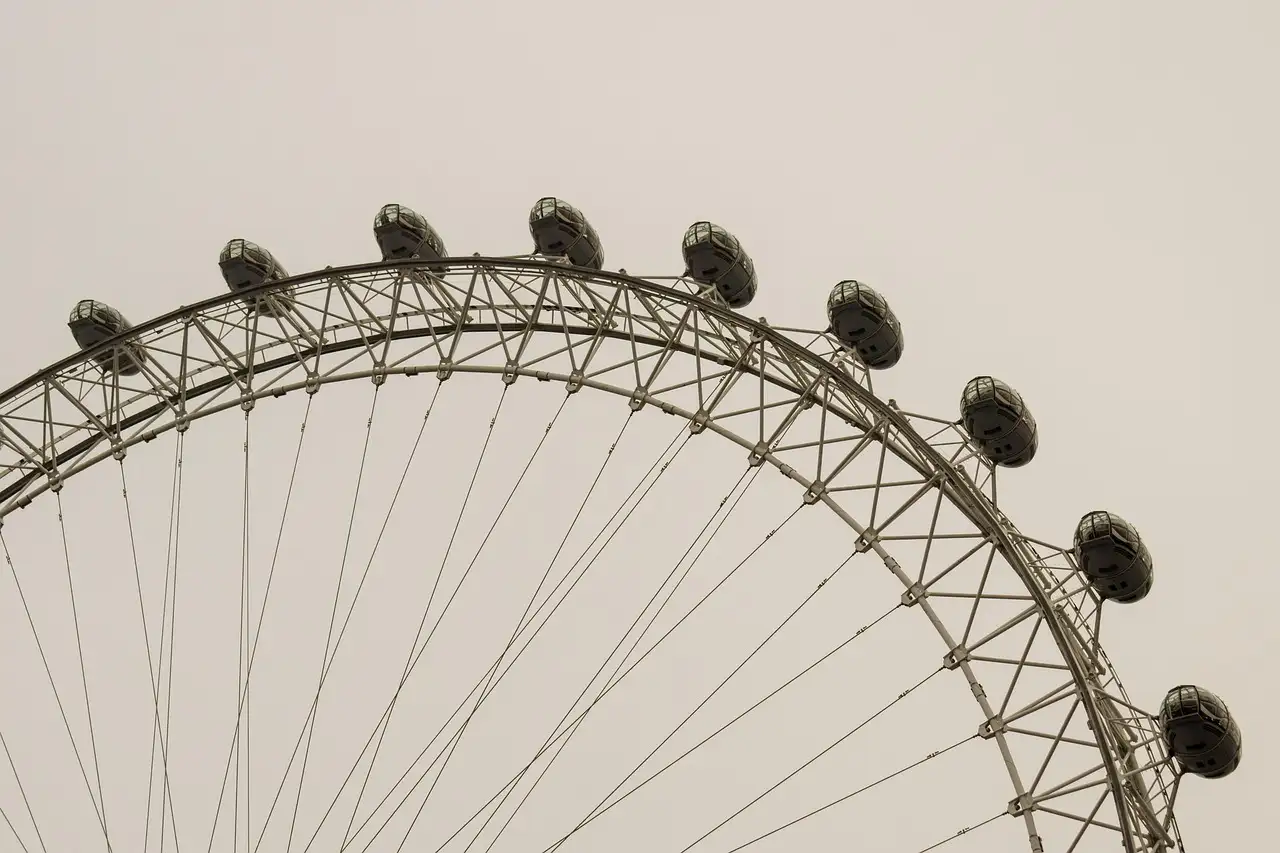 The curved rim of the London Eye with its capsules, seen from below