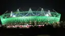 The London Olympic Stadium lit green at night