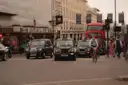 Central London street with black cabs, a cyclist and a red double-decker bus
