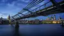 The Millennium Bridge over the Thames at dusk, with St Paul's dome behind