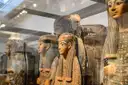 Painted ancient Egyptian coffins in a museum display case