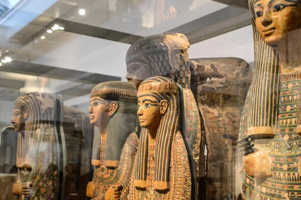 Painted ancient Egyptian coffins in a museum display case