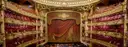 A gilded opera-house auditorium with tiers of boxes around the stage