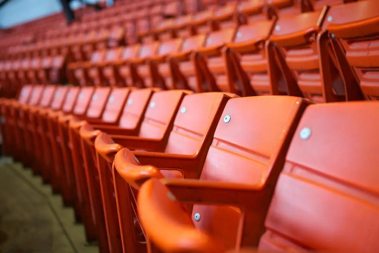 Curving rows of orange stadium seats