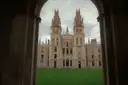 All Souls College towers in Oxford framed by a stone archway