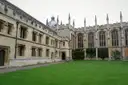 Oxford college quadrangle with gothic windows around a green lawn