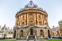 The round Radcliffe Camera library in Oxford under a pale sky