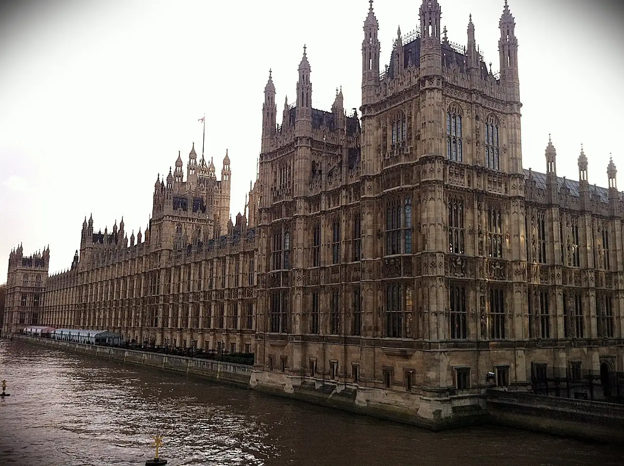 Gothic river front of the Palace of Westminster beside the Thames