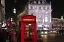 A red telephone box at Piccadilly Circus at night