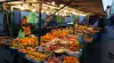 A fruit and vegetable stall on Portobello Road Market under strings of lights